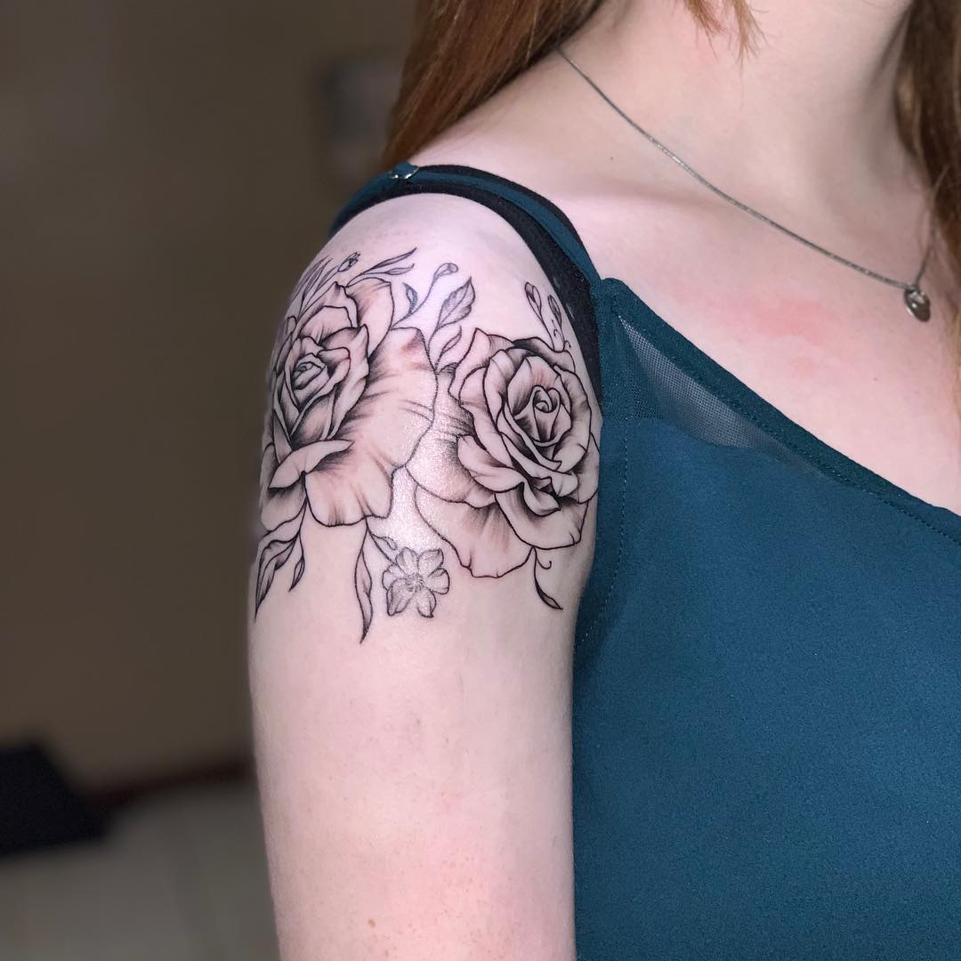 black and white arm and shoulder tattoo of a rose