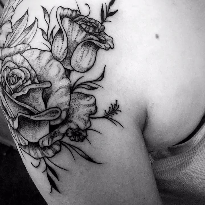 Image of intricate rose shoulder tattoo