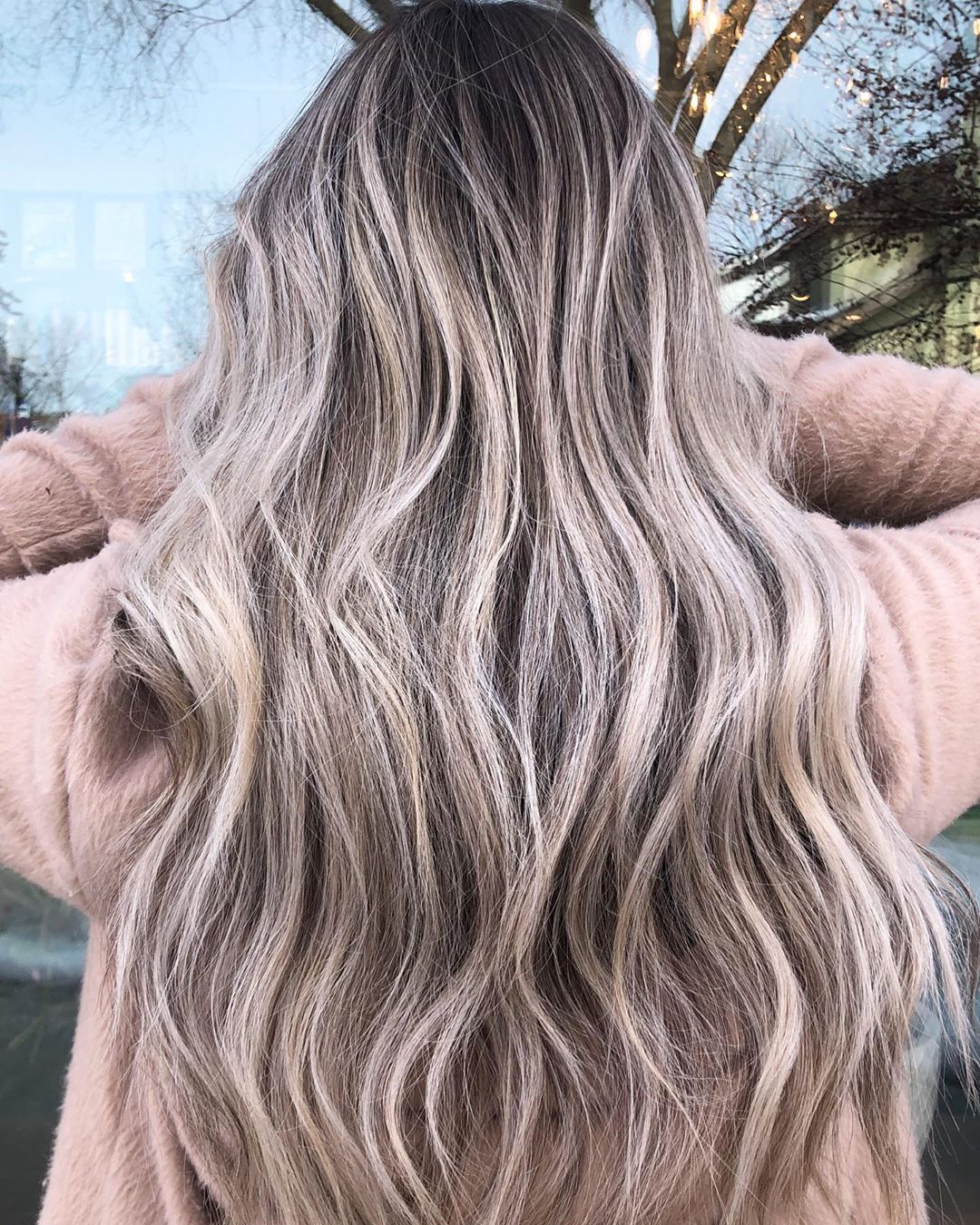 Image of dark roots on a blonde hair style