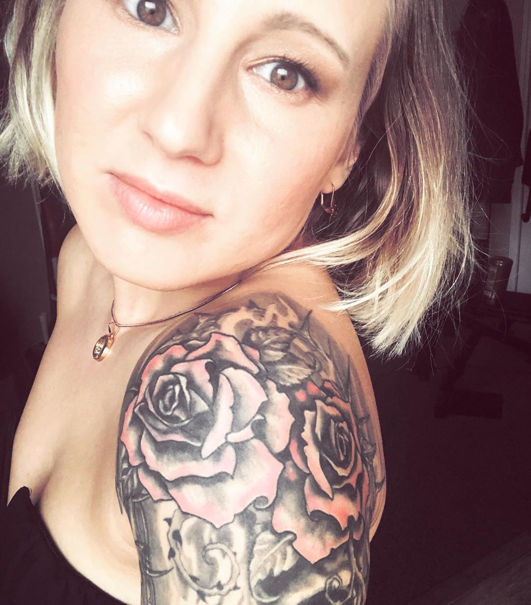 Image of pink and black rose shoulder tattoo