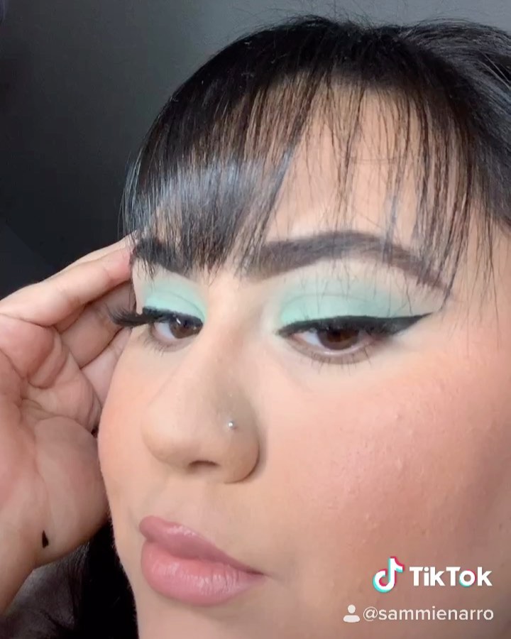 Mint color eyeshadow and winged eyeliner