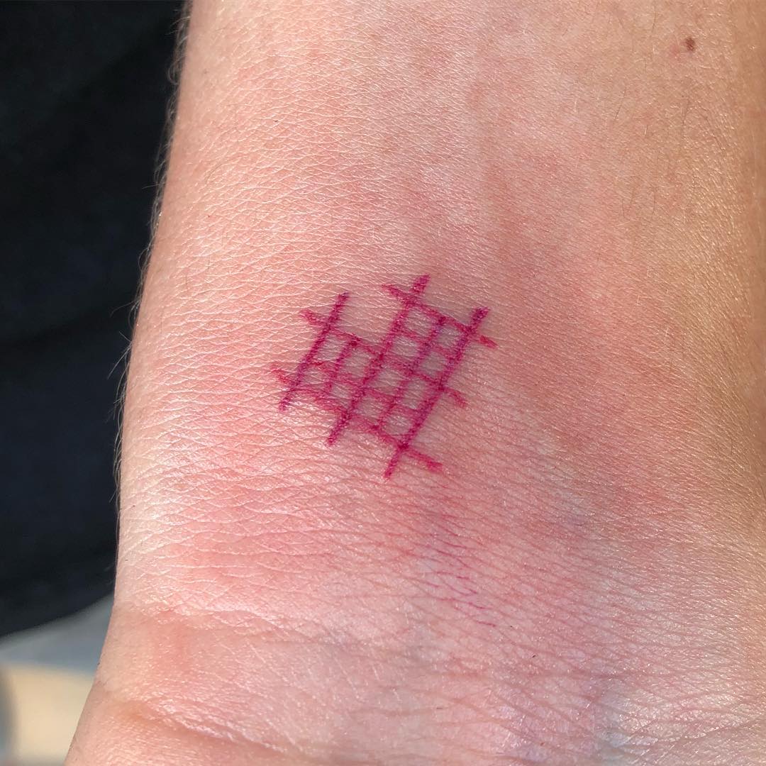 Image of cross stitch tattoo