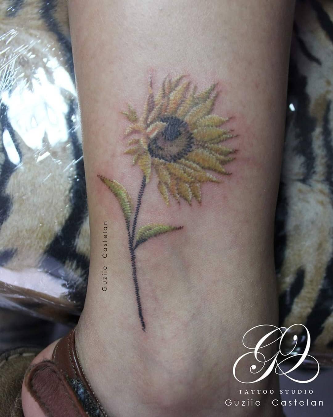 Beautiful image of a small sunflower tattoo