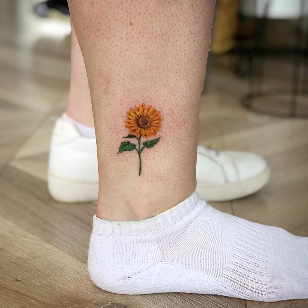 Beautiful image of a small sunflower tattoo
