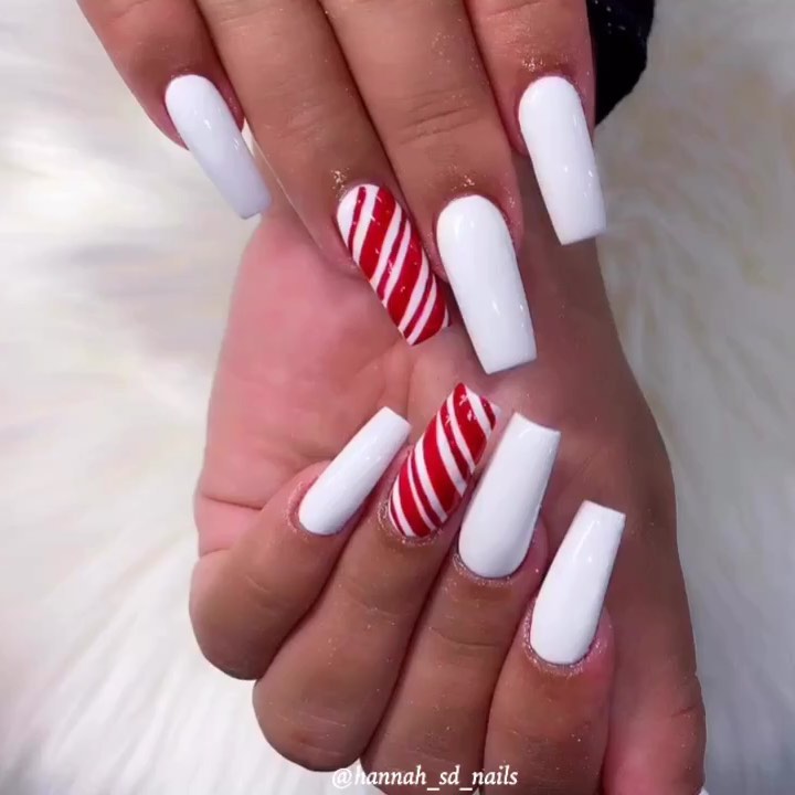 Image of mostly white nails with a peppermint red twist as a candy cane